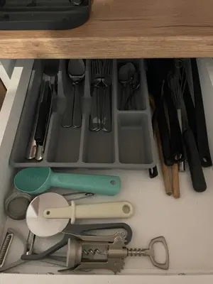 a drawer full of kitchen utensils in a cabinet at Urban Oasis Apartment in Sajmište