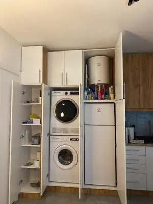 a kitchen with a washing machine and a washer at Urban Oasis Apartment in Sajmište