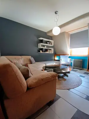 a living room with a couch and a table at On The Terrace La Vida Joy Mansard Top Kitchen in Belgrade