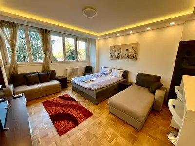 a living room with a bed and a couch at Fontana Studio in Belgrade