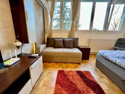 a living room with a couch and a table at Fontana Studio in Belgrade