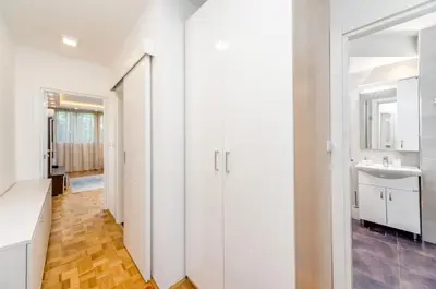 a bathroom with white cabinets and a sink at Fontana Studio in Belgrade