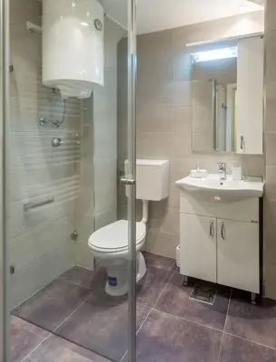 a bathroom with a toilet and a sink and a shower at Fontana Studio in Belgrade
