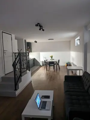 a living room with a couch and a table with a laptop at GardenGateStudio in Belgrade