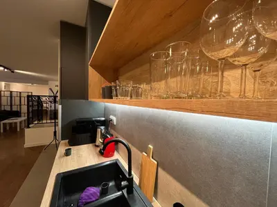 a kitchen with a sink and glasses on the counter at GardenGateStudio in Belgrade