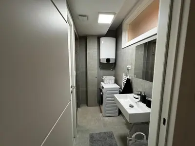 a small bathroom with a sink and a toilet at GardenGateStudio in Belgrade