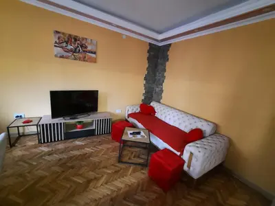 a living room with a teddy bear sitting on a couch at G&S apartment in Novi Beograd
