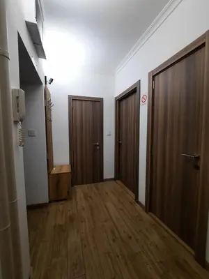 a hallway with two doors and wooden floors at G&S apartment in Novi Beograd