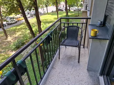 a chair sitting on the balcony of a house at G&S apartment in Novi Beograd