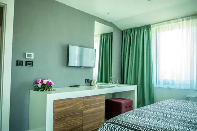 a bedroom with a bed and a sink and a mirror at Hotel Hedonic in Belgrade