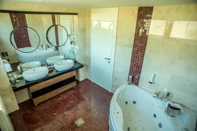a bathroom with two sinks and a tub and a shower at Hotel Hedonic in Belgrade