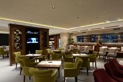 a restaurant with tables and chairs and a television at Hotel Hedonic in Belgrade
