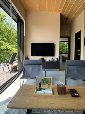a living room with a tv and a table at Chado Belgrade in Belgrade