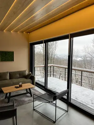 a living room with a couch and a table at Chado Belgrade in Belgrade