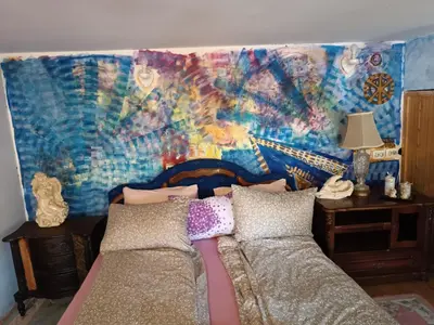 a bedroom with a bed and a painting on the wall at Maravilja 23 in Filmski Grad