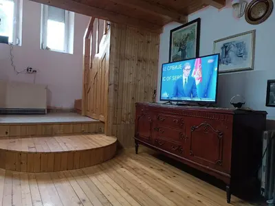 a living room with a television on a wooden dresser at Maravilja 23 in Filmski Grad