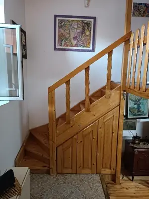 a wooden staircase in a room with a stair case at Maravilja 23 in Filmski Grad