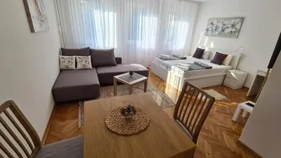 a living room with a couch and a table at All In One Studio in Belgrade