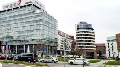 a city with cars parked in front of buildings at All In One Studio in Belgrade