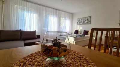 a glass vase on a table in a living room at All In One Studio in Belgrade