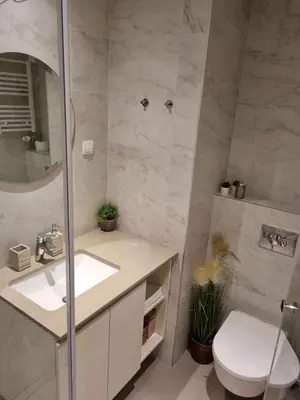 a bathroom with a toilet and a sink and a mirror at All in One Belgrade Waterfront in Sajmište