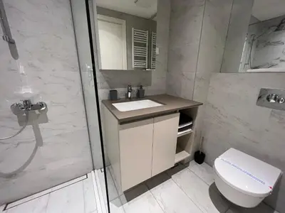 a bathroom with a toilet and a sink and a shower at Belgrade Waterfront Lux Studio Apartment in Belgrade