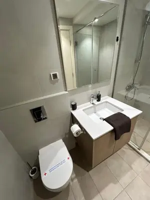 a bathroom with a sink and a toilet and a mirror at Belgrade Waterfront Lux Studio Apartment in Belgrade