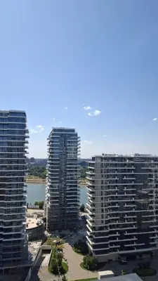 three tall buildings with a river in the background at Belgrade Waterfront Lux Studio Apartment in Belgrade
