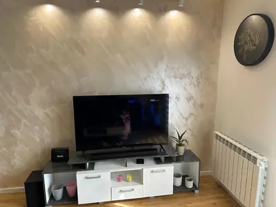 a flat screen tv sitting on top of a white entertainment center at Apartman Uno Lux in Novi Grad
