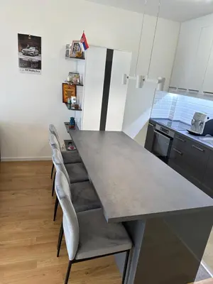 a kitchen with a gray table and chairs at Apartman Uno Lux in Novi Grad