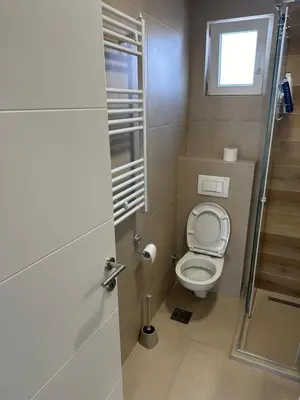 a small bathroom with a toilet and a window at Apartman Uno Lux in Novi Grad