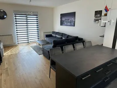 a living room with a couch and a table at Apartman Uno Lux in Novi Grad