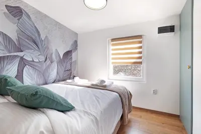 a bedroom with a bed and a window at Theater Apartment in Vračar (historical)