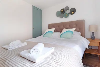 a bedroom with a large bed with towels on it at Theater Apartment in Vračar (historical)