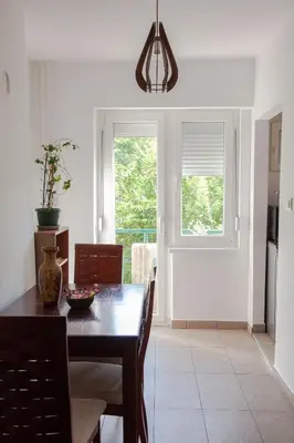 a dining room with a table and a window at Apartment Lea in Belgrade