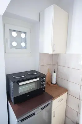 a kitchen with a toaster oven on a counter at Apartment Lea in Belgrade
