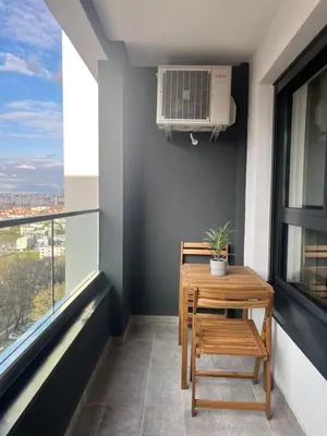 a room with a table and chair and a window at IVA HOME Apartment in Belgrade