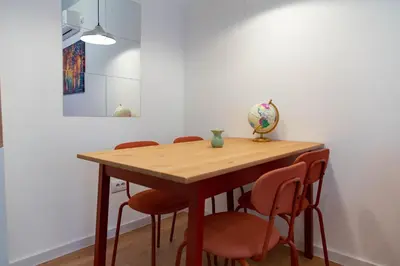 a wooden table with four chairs in a room at AV Smart Apartment in Pančevo