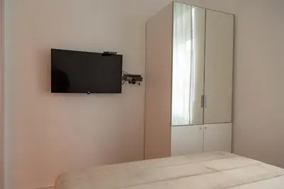a bedroom with a flat screen tv on the wall at AV Smart Apartment in Pančevo