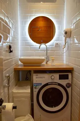 a bathroom with a washing machine and a sink at AV Smart Apartment in Pančevo