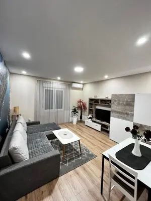 a living room with a couch and a table at Apartman Natali in Karaburma
