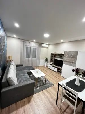 a living room with a couch and a table at Apartman Natali in Karaburma