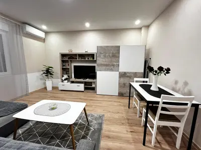 a living room with a table and chairs at Apartman Natali in Karaburma