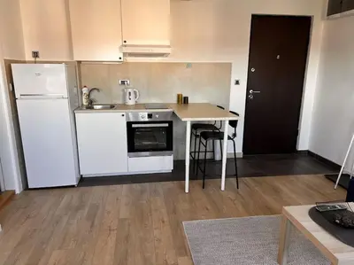 a kitchen with a white refrigerator and a table at Daki apartment in Belgrade
