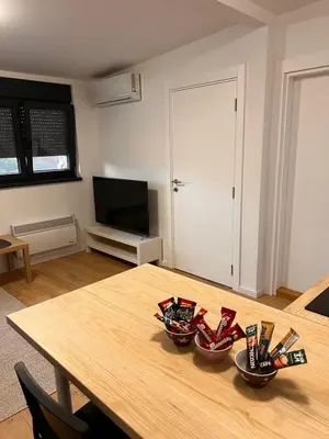 a room with a wooden table with three bowls on it at Daki apartment in Belgrade