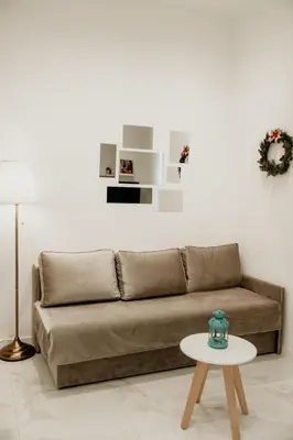a living room with a brown couch and a table at Sweet Home in Belgrade