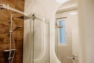 a bathroom with a shower and a mirror at Sweet Home in Belgrade
