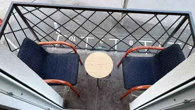 two chairs and a table on a balcony at Apartman Comfort Beograd in Belgrade