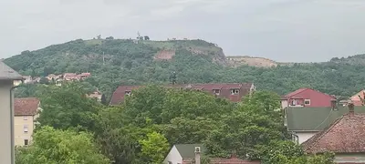a town with a hill in the background with houses at Apartman Comfort Beograd in Belgrade