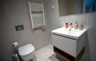 a bathroom with a white sink and a toilet at inJoy in Sajmište